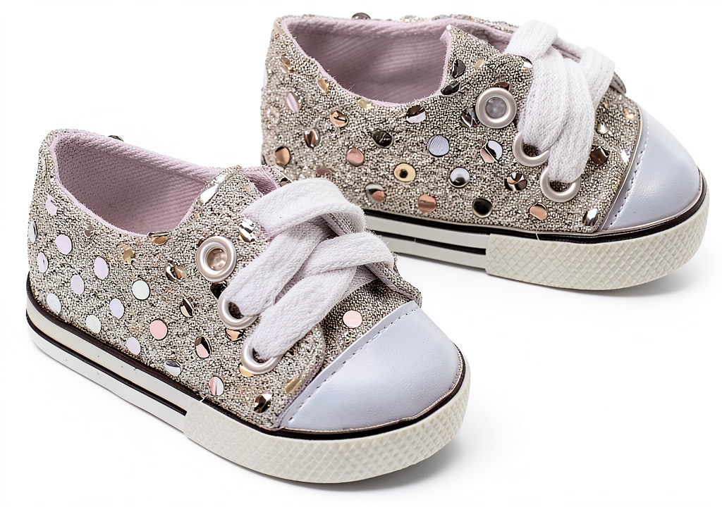 Silver lace up sequin doll shoes displayed on a 18 inch doll